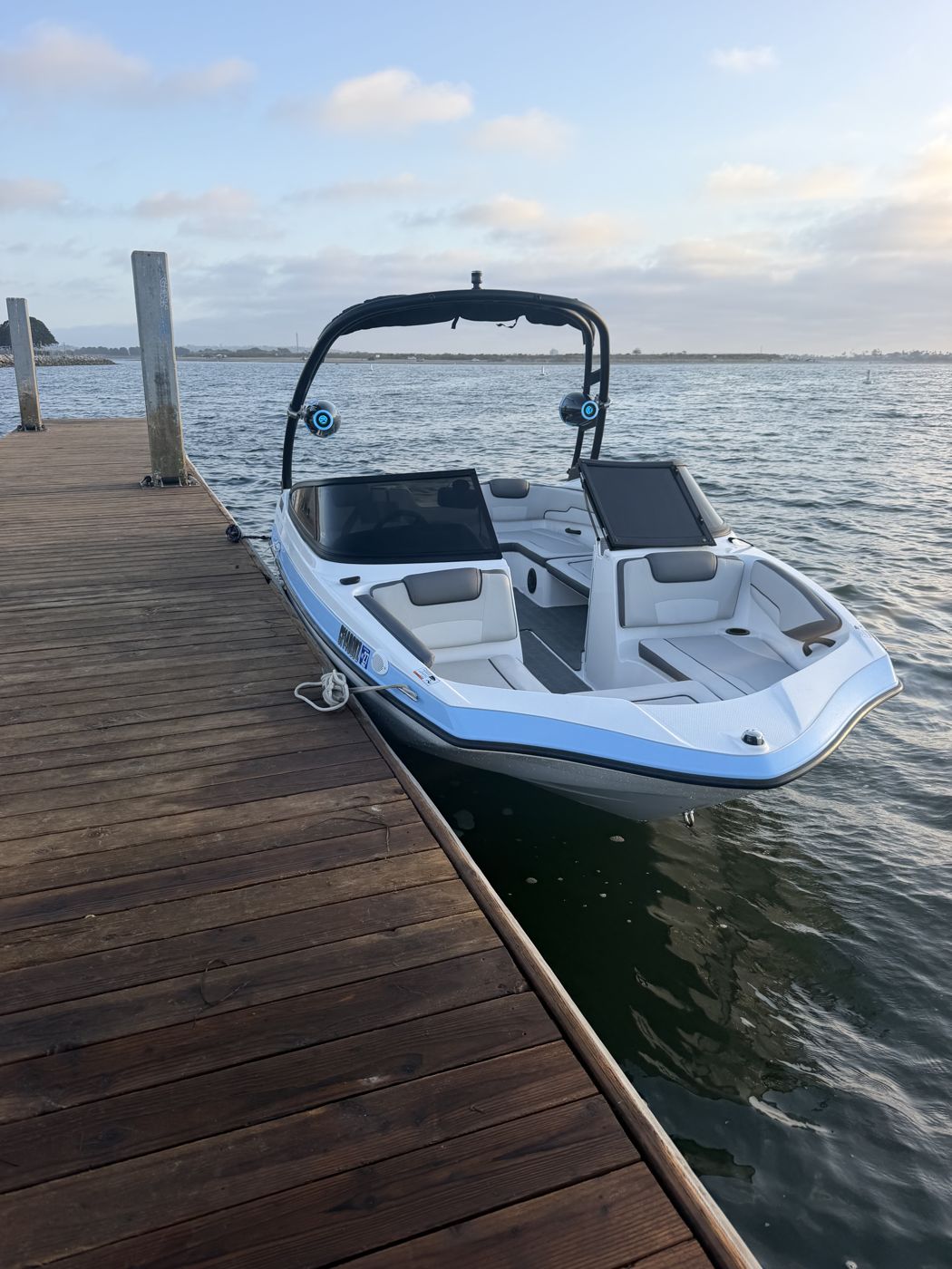 The M&M Legacy boat tied up at the dock at sunset