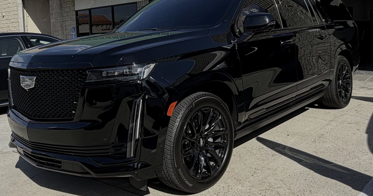 The black M&M Legacy Cadillac Escalade ESV, front three-quarter view